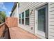 A wooden deck is attached to the house; a sliding glass door is visible with exterior lighting above at 1341 Rosen Rd, Brookhaven, GA 30319