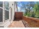 Home has a spacious back deck with wood railing and wooden floors, with a view of the treeline at 1341 Rosen Rd, Brookhaven, GA 30319