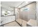 Modern bathroom featuring a glass shower with tile surround, white cabinets, and granite countertops at 1341 Rosen Rd, Brookhaven, GA 30319
