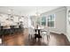 Bright dining area features large windows, a modern chandelier, and a stylish round table with white chairs at 1341 Rosen Rd, Brookhaven, GA 30319