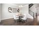 Dining area with a round table, stylish chairs, modern artwork, and view of the staircase at 1341 Rosen Rd, Brookhaven, GA 30319