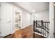 Bright upstairs hallway featuring hardwood floors, white walls and doors, leading to the bathroom at 1341 Rosen Rd, Brookhaven, GA 30319