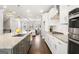 Modern kitchen with a large island, granite countertops, white cabinets, and stainless steel appliances at 1341 Rosen Rd, Brookhaven, GA 30319