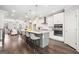 Spacious kitchen featuring white cabinets, stainless appliances, a large island with seating, and modern fixtures at 1341 Rosen Rd, Brookhaven, GA 30319