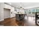 Bright kitchen with a large island, white cabinets, stainless steel appliances, and modern pendant lighting at 1341 Rosen Rd, Brookhaven, GA 30319