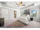 Bright main bedroom featuring tray ceilings, neutral walls, and ensuite bathroom access at 1341 Rosen Rd, Brookhaven, GA 30319