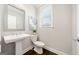Stylish powder room with a pedestal sink, modern faucet, and dark wood floors at 1341 Rosen Rd, Brookhaven, GA 30319