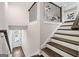 A staircase with dark wood treads and white risers leads to the main floor of the home, highlighting a bright entryway at 1341 Rosen Rd, Brookhaven, GA 30319