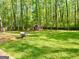 Large backyard featuring mature trees, a storage shed, and lush lawn at 149 Wimberly Way, Powder Springs, GA 30127