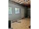 Unfinished basement with two windows and a door leading to the backyard at 149 Wimberly Way, Powder Springs, GA 30127