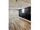 Basement area featuring gray plank flooring, black accent wall, and a window at 149 Wimberly Way, Powder Springs, GA 30127