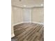 Finished basement featuring a neutral paint palette and wood-look laminate flooring at 149 Wimberly Way, Powder Springs, GA 30127