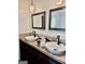 Charming bathroom featuring dual sinks with decorative faucets and mosaic tile countertop and unique light fixture at 149 Wimberly Way, Powder Springs, GA 30127