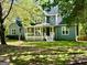 Charming gray home featuring a welcoming front porch and well-maintained lawn at 149 Wimberly Way, Powder Springs, GA 30127
