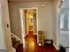 Hallway features wood floors leading to bathroom, staircase, and front room at 149 Wimberly Way, Powder Springs, GA 30127
