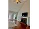 Living room with brick fireplace, flatscreen TV, ceiling fan, and door to the backyard at 149 Wimberly Way, Powder Springs, GA 30127