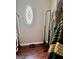 Neat walk-in closet featuring dark wood flooring, an oval window, and ample storage space at 149 Wimberly Way, Powder Springs, GA 30127