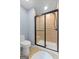 Bathroom showcasing a tiled shower with a glass door and a toilet at 406 Kenley Ct, Mcdonough, GA 30253