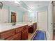 Bathroom with dual sink vanities and a large mirror at 406 Kenley Ct, Mcdonough, GA 30253