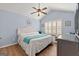Cozy bedroom with vaulted ceiling, ceiling fan and light blue walls and hardwood floors at 406 Kenley Ct, Mcdonough, GA 30253