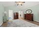 Bedroom with vaulted ceiling, ceiling fan, hardwood floors, and two dressers at 406 Kenley Ct, Mcdonough, GA 30253