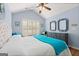 Bedroom with vaulted ceiling, ceiling fan, wood floors, plantation shutters and blue walls at 406 Kenley Ct, Mcdonough, GA 30253
