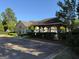 Exterior view of the clubhouse with covered pavilion and manicured landscaping at 406 Kenley Ct, Mcdonough, GA 30253