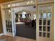 Clubhouse interior featuring French doors leading to a spacious area with elegant furnishings and natural light at 406 Kenley Ct, Mcdonough, GA 30253