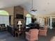 Clubhouse interior showcasing a stone fireplace, comfortable seating, arched windows, and abundant natural light at 406 Kenley Ct, Mcdonough, GA 30253