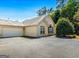 Charming home featuring a stone facade, attached garage, and landscaped front yard at 406 Kenley Ct, Mcdonough, GA 30253