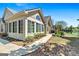 Beautiful home exterior with a walkway, lush lawn and mature trees, and an outdoor grill area at 406 Kenley Ct, Mcdonough, GA 30253