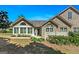 Charming single-story home featuring a stone facade, shuttered windows, and well-maintained landscaping at 406 Kenley Ct, Mcdonough, GA 30253