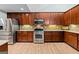 Spacious kitchen showcasing stainless steel appliances, wood cabinets, and granite countertops at 406 Kenley Ct, Mcdonough, GA 30253
