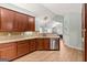 Kitchen featuring wood cabinets, granite counters, stainless steel appliances, and views of the living area at 406 Kenley Ct, Mcdonough, GA 30253