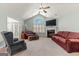Spacious living room featuring a fireplace, vaulted ceilings, ceiling fan, and bright natural light at 406 Kenley Ct, Mcdonough, GA 30253