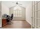 Office featuring an arched window, ceiling fan, french doors, and luxury vinyl plank flooring at 406 Kenley Ct, Mcdonough, GA 30253