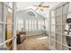 Sun room with large windows, neutral colored walls, and access to the rest of the home through french doors at 406 Kenley Ct, Mcdonough, GA 30253