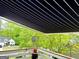 View of the retractable awning over the deck with lush green surroundings at 3870 Michaels Creek Ct, Loganville, GA 30052