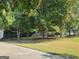 Lush backyard featuring mature trees, a swing set, and a spacious lawn at 3870 Michaels Creek Ct, Loganville, GA 30052