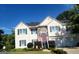 Charming two-story home featuring stone accents, a well-manicured lawn, and a welcoming red front door at 3870 Michaels Creek Ct, Loganville, GA 30052