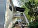 Two story home with white siding, deck, awning and stairs leading to the yard at 3870 Michaels Creek Ct, Loganville, GA 30052