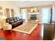 Cozy living room with a stone fireplace, hardwood floors, and comfortable seating, perfect for relaxing at 3870 Michaels Creek Ct, Loganville, GA 30052