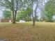 Spacious backyard with mature trees, outbuildings and plenty of room to enjoy outdoor activities at 103 Belair Ln, Stockbridge, GA 30281