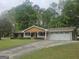 Charming brick home with a welcoming front porch, well-manicured lawn, and an attached two-car garage at 103 Belair Ln, Stockbridge, GA 30281