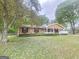 Lovely brick home with a blooming tree, fresh green lawn, and an inviting front porch at 103 Belair Ln, Stockbridge, GA 30281