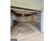 Large garage space, featuring fluorescent lighting, concrete floor, and shelving at 103 Belair Ln, Stockbridge, GA 30281