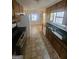 Bright kitchen offering tile flooring, black countertops, and wood cabinets at 103 Belair Ln, Stockbridge, GA 30281