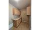 Functional kitchen area with wood cabinets and neutral countertops, offering practical storage at 103 Belair Ln, Stockbridge, GA 30281