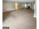 Large open living room with a brick fireplace, light walls, and carpet flooring at 103 Belair Ln, Stockbridge, GA 30281