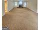 Spacious living room with a brick fireplace and neutral carpet at 103 Belair Ln, Stockbridge, GA 30281